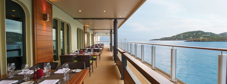Where can you find this outdoor space where cruisers enjoy their evening meal with a view as they sail out of port?