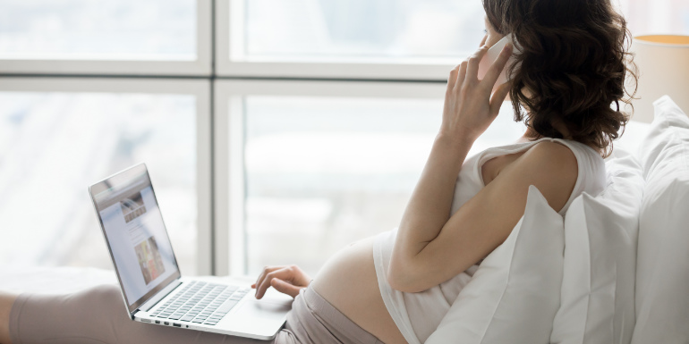young-woman-pregnant-laptop-phone-cruising
