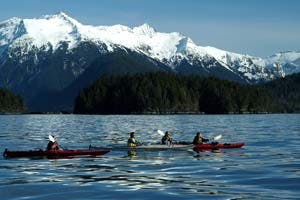 kayakers alaska anchorage lake with mountains